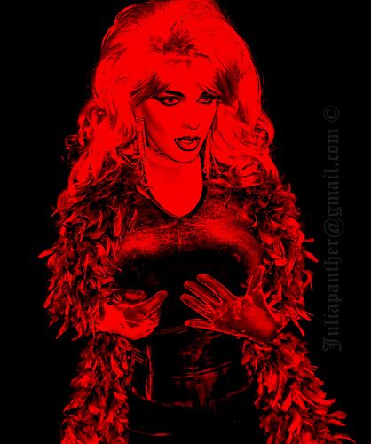 Glamour in red light: diva in velvet and feather