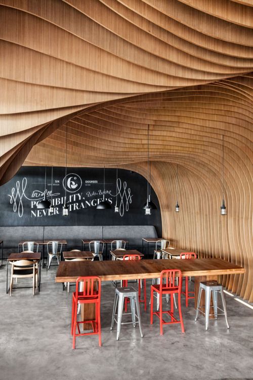 dezeen: OOZN Design creates cavernous cafeÂ in Jakarta using undulating timber slats