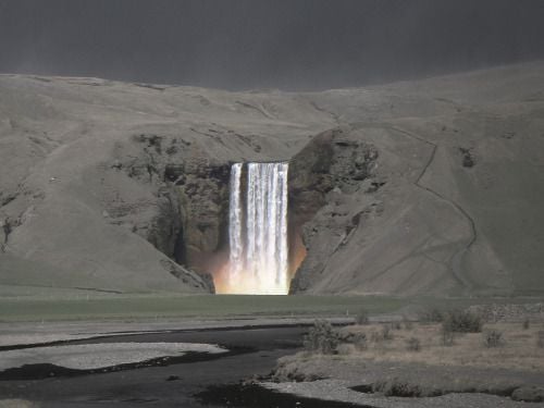 Waterfall amidst a mountain covered in ash after a volcano eruption.Â  Taken in Iceland.
