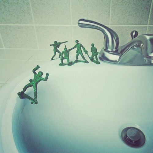 brockdavis: At ease, soldier. My son asked me why his army men are on standing on skateboards. So we made this scene for fun. Cut the rifle out of this soldierâs hands, glued rocket launcher pieces to make the wheels and glued him to the sink.Â 