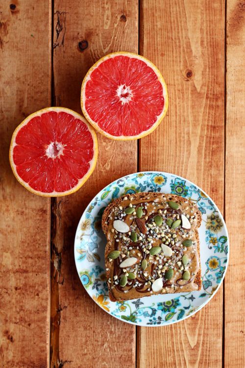 garden-of-vegan: Pink grapefruit and toasted Silver Hills âSquirrellyâ bread topped with almond butter and dark chocolate, hemp seeds, buckwheat groats, pumpkin seeds and slivered almonds.